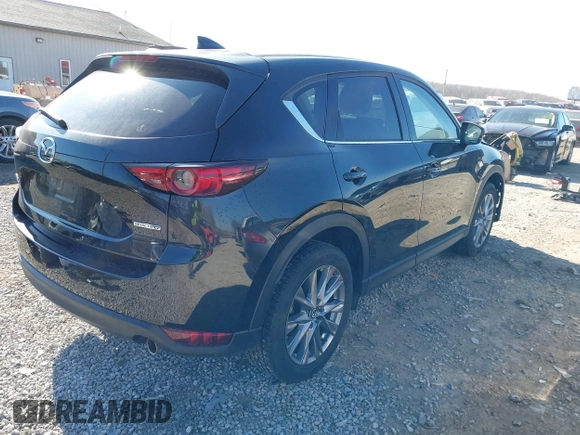 2021 Mazda CX-5 Grand Touring with VIN JM3KFBDM0M0468081, listed as a IAAI auction lot 41894411 with 54,664 mi miles. Bid and sale history available at carsss.com. Image 4.