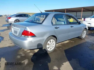 2006 Mitsubishi Lancer ES with VIN JA3AJ26E06U057959, listed as a IAAI auction lot 41347649 with 122,963 mi miles. Bid and sale history available at carsss.com. Image 4.