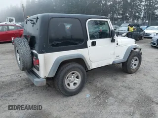 2006 Jeep Wrangler Sport Right Hand Drive with VIN 1J4F449S16P709895, listed as a IAAI auction lot 41349311 with 157,125 mi miles. Bid and sale history available at carsss.com. Image 4.