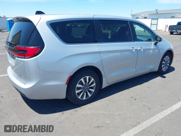 2023 Chrysler Pacifica Hybrid Touring L with VIN 2C4RC1L75PR614460, listed as a IAAI auction lot 42628545 with 68,668 mi miles and . Bid and sale history available at DreamBid. Image 4.