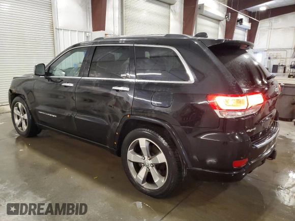 2015 Jeep Grand Cherokee Overland with VIN 1C4RJFCG7FC911899, listed as a Copart auction lot 54123925 with 243,031 mi miles and Salvage Title. Bid and sale history available at carsss.com. Image 2.