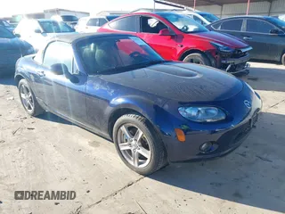 2007 Mazda MX-5 Miata Sport z VIN JM1NC25F770129613, wystawiony jako IAAI lot #41481932 z przebiegiem 98 953 mil mil oraz . Historia ofert i sprzedaży dostępna na DreamBid. Obrazek 1.
