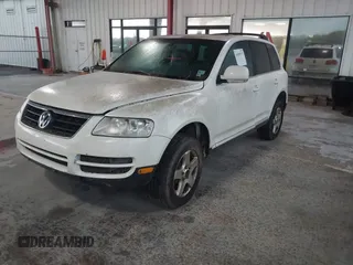 2004 Volkswagen Touareg with VIN WVGBC67L04D026451, listed as a IAAI auction lot 41859371 with 151,392 mi miles and . Bid and sale history available at DreamBid. Image 2.