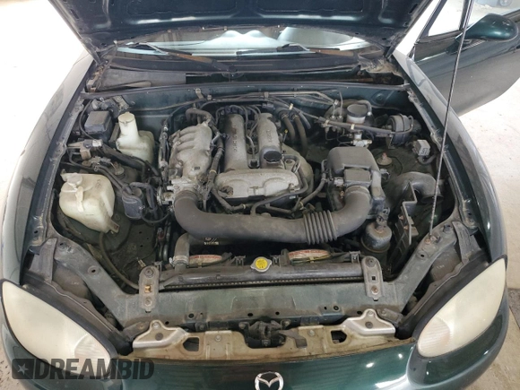 1999 Mazda MX-5 Miata z VIN JM1NB353XX0111850, wystawiony jako Copart lot #53076805 z przebiegiem 128 707 mil mil oraz Szkoda całkowita • Salvage title. Historia ofert i sprzedaży dostępna na DreamBid. Obrazek 11.
