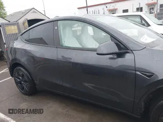 2025 Tesla Model Y Long Range with VIN 7SAYGDED8SA340082, listed as a IAAI auction lot 41915369 with 7,296 mi miles and . Bid and sale history available at carsss.com. Image 14.