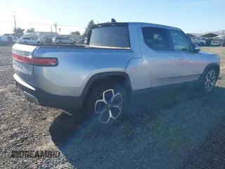 2023 Rivian R1T Adventure with VIN 7FCTGAAA0PN021864, listed as a IAAI auction lot 41620630 with 1 mi miles. Bid and sale history available at carsss.com. Image 4.