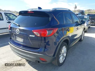 2014 Mazda CX-5 Grand Touring with VIN JM3KE2DY7E0376389, listed as a IAAI auction lot 42014946 with 126,081 mi miles. Bid and sale history available at carsss.com. Image 4.