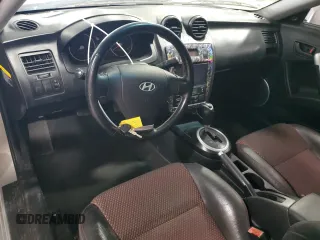 2006 Hyundai Tiburon GT z VIN KMHHN65F96U203924, wystawiony jako Copart lot #43624185 z przebiegiem 120 403 mil mil oraz Szkoda całkowita • Salvage title. Historia ofert i sprzedaży dostępna na DreamBid. Obrazek 8.