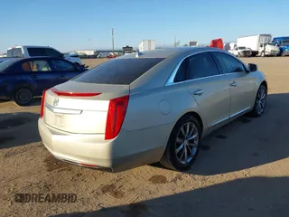 2014 Cadillac XTS with VIN 2G61L5S30E9207777, listed as a IAAI auction lot 41202654 with 112,565 mi miles. Bid and sale history available at carsss.com. Image 4.