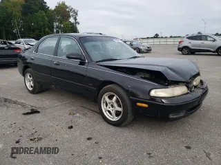 1996 Mazda 626 z VIN 1YVGE22C2T5585359, wystawiony jako Copart lot #74568444 z przebiegiem 159 922 mil mil oraz Szkody całkowita. Historia ofert i sprzedaży dostępna na DreamBid. Obrazek 4.