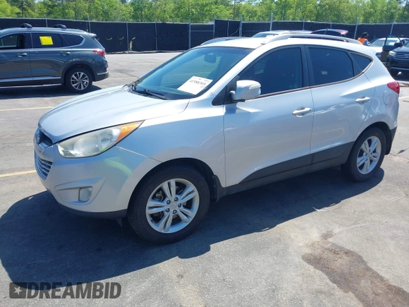 2013 Hyundai Tucson GLS with VIN KM8JU3AC3DU551018, listed as a IAAI auction lot 41988305 with 214,728 mi miles. Bid and sale history available at carsss.com. Image 2.