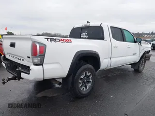 2021 Toyota Tacoma SR5 with VIN 3TMDZ5BN1MM100575, listed as a IAAI auction lot 41516274 with 61,974 mi miles and . Bid and sale history available at DreamBid. Image 4.