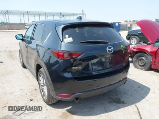 2020 Mazda CX-5 Grand Touring with VIN JM3KFADM1L0781634, listed as a IAAI auction lot 42333769 with 103,080 mi miles and . Bid and sale history available at DreamBid. Image 3.
