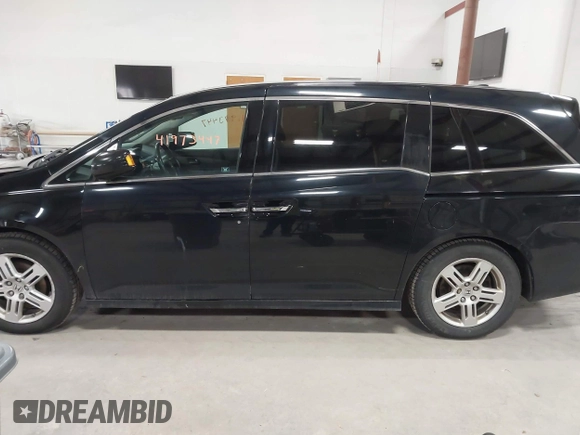 2011 Honda Odyssey Touring with VIN 5FNRL5H9XBB055008, listed as a IAAI auction lot 41973447 with 218,762 mi miles and . Bid and sale history available at DreamBid. Image 14.