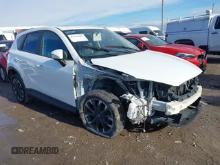 2016 Mazda CX-5 Grand Touring z VIN JM3KE4DY5G0725824, wystawiony jako IAAI lot #41544966 z przebiegiem 133 188 mil mil oraz . Historia ofert i sprzedaży dostępna na DreamBid. Obrazek 1.