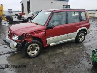 1998 Suzuki Sidekick z VIN JS3TD21VXW4103386, wystawiony jako Copart lot #86219924 z przebiegiem 172 959 mil mil oraz Szkody całkowita. Historia ofert i sprzedaży dostępna na DreamBid. Obrazek 1.