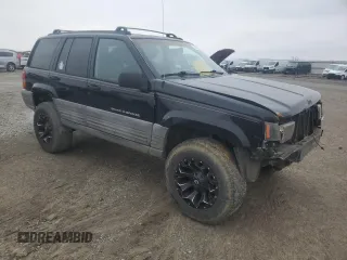1998 Jeep Grand Cherokee Laredo with VIN 1J4GZ58S2WC281923, listed as a Copart auction lot 44010885 with 210,959 mi miles and Salvage Title. Bid and sale history available at carsss.com. Image 4.