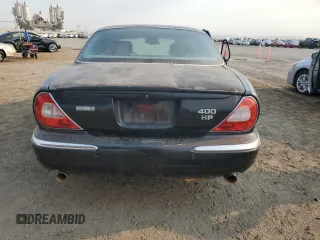 2004 Jaguar XJ with VIN SAJWA73B74TG18082, listed as a Copart auction lot 70516404 with 0 mi miles and Salvage Title. Bid and sale history available at carsss.com. Image 6.