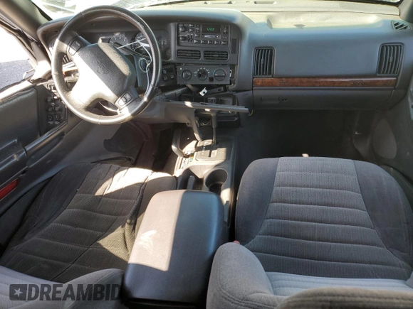 1997 Jeep Grand Cherokee Laredo with VIN 1J4GZ58S5VC561060, listed as a Copart auction lot 52098315 with 267,245 mi miles and Salvage title. Bid and sale history available at DreamBid. Image 8.