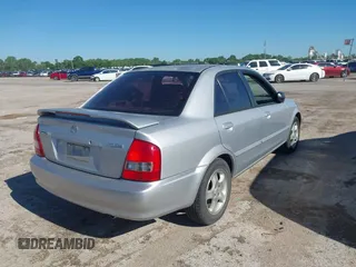 2000 Mazda Protege ES with VIN JM1BJ2213Y0284890, listed as a IAAI auction lot 42088671 with 215,104 mi miles and . Bid and sale history available at DreamBid. Image 4.