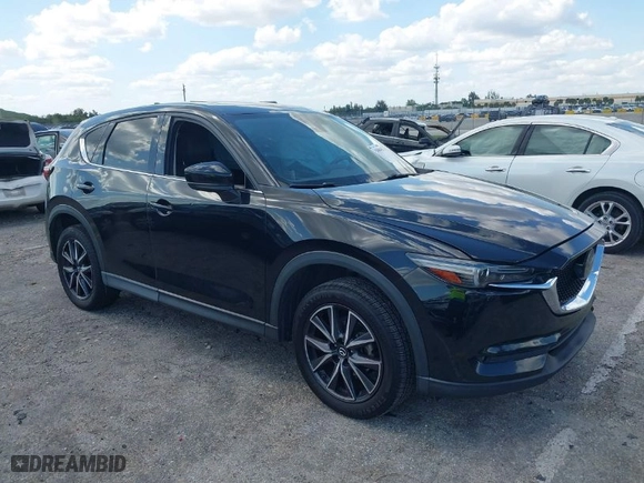 2018 Mazda CX-5 Grand Touring with VIN JM3KFBDM2J0390611, listed as a IAAI auction lot 42006482 with 97,497 mi miles. Bid and sale history available at carsss.com. Image 1.