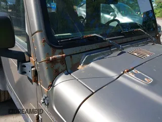 2003 Jeep Wrangler Sport z VIN 1J4FA49S13P313180, wystawiony jako IAAI lot #42349673 z przebiegiem 141 073 mil mil oraz . Historia ofert i sprzedaży dostępna na DreamBid. Obrazek 6.