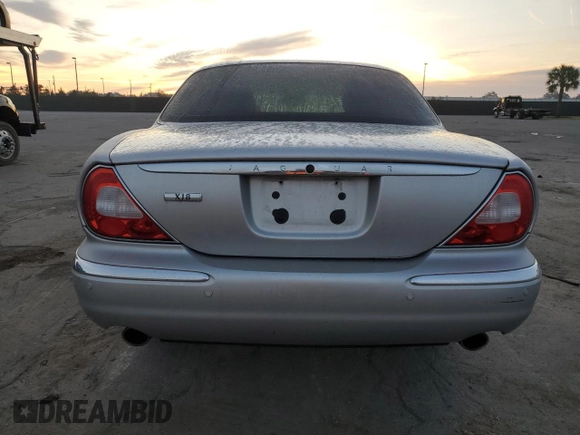 2004 Jaguar XJ with VIN SAJEA71C54SG01326, listed as a Copart auction lot 77449324 with 72,935 mi miles and Salvage Title. Bid and sale history available at carsss.com. Image 6.