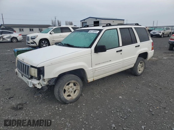 1998 Jeep Grand Cherokee Laredo with VIN 1J4GZ48S1WC165851, listed as a Copart auction lot 84110044 with 306,484 mi miles and Salvage Title. Bid and sale history available at carsss.com. Image 1.