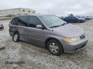 2000 Honda Odyssey EX with VIN 2HKRL1865YH513885, listed as a Copart auction lot 50223505 with 214,627 mi miles and Salvage Title. Bid and sale history available at DreamBid. Image 4.