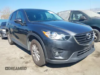 2016 Mazda CX-5 Touring with VIN JM3KE2CY8G0874248, listed as a IAAI auction lot 41679166 with 124,547 mi miles. Bid and sale history available at carsss.com. Image 1.