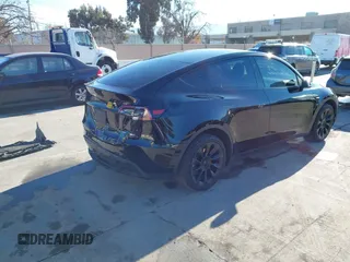 2024 Tesla Model Y Long Range with VIN 7SAYGDEEXRF983040, listed as a IAAI auction lot 41555332 with 79,506 mi miles and . Bid and sale history available at DreamBid. Image 4.