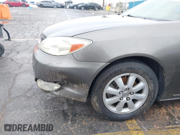 2004 Toyota Camry LE with VIN JTDBF32K740152841, listed as a IAAI auction lot 41808909 with 142,611 mi miles. Bid and sale history available at carsss.com. Image 6.