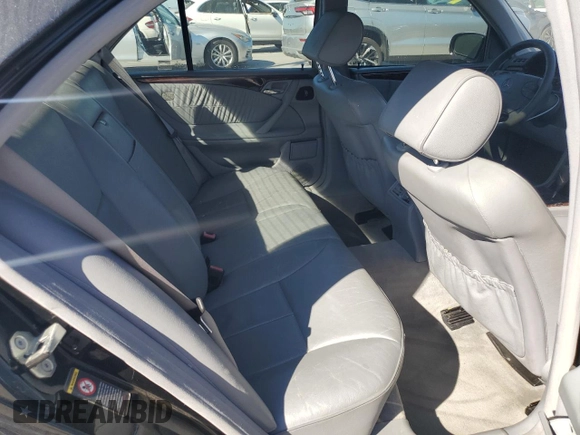 2000 Mercedes-Benz E-Class with VIN WDBJF70JXYB091085, listed as a Copart auction lot 77136484 with 185,429 mi miles and Salvage Title. Bid and sale history available at carsss.com. Image 10.