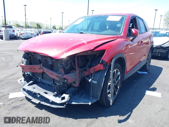 2016 Mazda CX-5 Grand Touring z VIN JM3KE2DY2G0660385, wystawiony jako IAAI lot #42101004 z przebiegiem 166 336 mil mil oraz . Historia ofert i sprzedaży dostępna na DreamBid. Obrazek 2.
