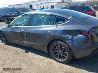 2020 Tesla Model 3 Standard Range Plus with VIN 5YJ3E1EA2LF634566, listed as a IAAI auction lot 41880994 with 65,395 mi miles. Bid and sale history available at carsss.com. Image 6.