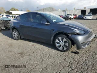 2021 Tesla Model Y Standard Range with VIN 5YJYGDED7MF109418, listed as a Copart auction lot 51590135 with 86,668 mi miles and Salvage Title. Bid and sale history available at DreamBid. Image 4.