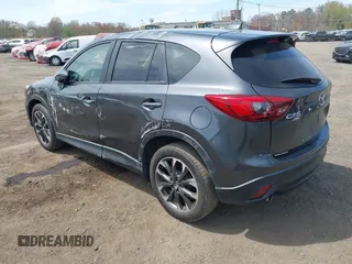 2016 Mazda CX-5 Grand Touring z VIN JM3KE4DY1G0893119, wystawiony jako IAAI lot #42049614 z przebiegiem 102 506 mil mil oraz . Historia ofert i sprzedaży dostępna na DreamBid. Obrazek 3.