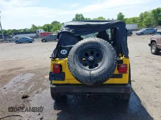 2005 Jeep Wrangler Sport z VIN 1J4FA49S65P381798, wystawiony jako IAAI lot #42305109 z przebiegiem 71 880 mil mil oraz . Historia ofert i sprzedaży dostępna na DreamBid. Obrazek 16.