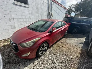 2014 Hyundai Elantra Coupe with VIN KMHDH6AH9EU025573, listed as a Copart auction lot 87049884 with 103,713 mi miles and Clean Title. Bid and sale history available at carsss.com. Image 2.