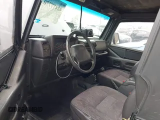 2002 Jeep Wrangler Sport with VIN 1J4FA49S02P705470, listed as a IAAI auction lot 42477770 with 59,395 mi miles and . Bid and sale history available at DreamBid. Image 5.