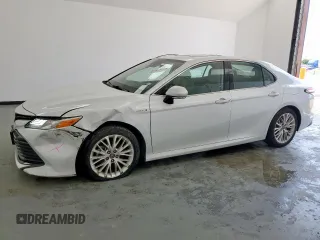 2019 Toyota Camry Hybrid LE z VIN 4T1B21HK1KU512324, wystawiony jako Copart lot #59232495 z przebiegiem 42 358 mil mil oraz Czysty tytuł • Clean title. Historia ofert i sprzedaży dostępna na DreamBid. Obrazek 1.