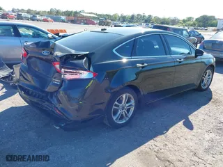 2015 Ford Fusion Titanium Hybrid with VIN 3FA6P0RUXFR119698, listed as a IAAI auction lot 41791411 with 140,646 mi miles. Bid and sale history available at carsss.com. Image 4.
