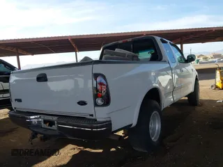 1999 Ford F-150 XL with VIN 2FTRX18L9XCA21004, listed as a IAAI auction lot 41616300 with 186,620 mi miles. Bid and sale history available at carsss.com. Image 4.