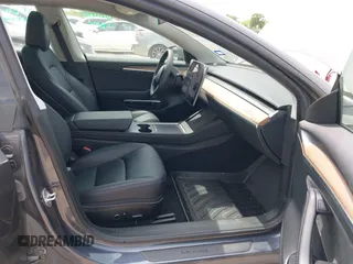 2023 Tesla Model 3 with VIN 5YJ3E1EA5PF565071, listed as a IAAI auction lot 42232719 with 15,389 mi miles and . Bid and sale history available at DreamBid. Image 5.