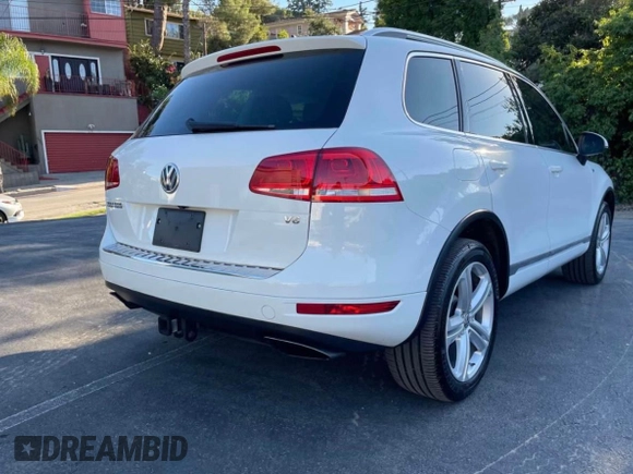 2014 Volkswagen Touareg Sport with VIN WVGEF9BP7ED003332, listed as a Copart auction lot 63043535 with 179,727 mi miles and Salvage title. Bid and sale history available at DreamBid. Image 4.