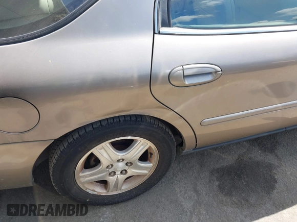 2002 Ford Taurus z VIN 1FAHP59U52G115825, wystawiony jako IAAI lot #41904552 z przebiegiem 91 004 mil mil oraz . Historia ofert i sprzedaży dostępna na DreamBid. Obrazek 6.