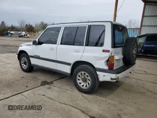 1996 Suzuki Sidekick JX z VIN 2S3TD03V7T6409487, wystawiony jako Copart lot #49977795 z przebiegiem 137 011 mil mil oraz Szkoda całkowita • Salvage title. Historia ofert i sprzedaży dostępna na DreamBid. Obrazek 2.