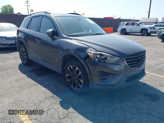 2016 Mazda CX-5 Grand Touring z VIN JM3KE2DY2G0661410, wystawiony jako IAAI lot #42385412 z przebiegiem 117 157 mil mil oraz . Historia ofert i sprzedaży dostępna na DreamBid. Obrazek 1.