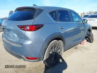 2021 Mazda CX-5 Touring with VIN JM3KFBCM9M0434433, listed as a IAAI auction lot 41425112 with 57,527 mi miles. Bid and sale history available at carsss.com. Image 4.