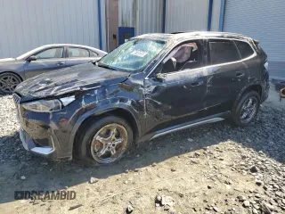 2025 BMW X1 xDrive28i with VIN WBX73EF00S5111795, listed as a Copart auction lot 48765255 with 12,042 mi miles and Salvage Title. Bid and sale history available at carsss.com. Image 1.